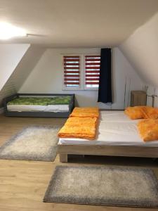 a bedroom with two beds and two rugs at Ferienhaus am Beetzsee in Päwesin