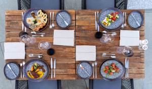 a table with plates of food and glasses of wine at HVD Reina del Mar - Premium Spa Service & Free Parking in Obzor