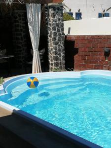 a swimming pool with a ball in the water at 5bedroom villa in perissa beach in Perissa