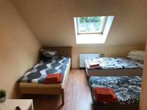 a small room with two beds and a window at Hotel Zakumuiza in Zaķumuiža