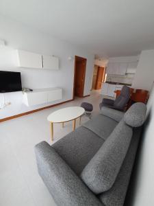 a living room with a couch and a table at La Colina in Albir
