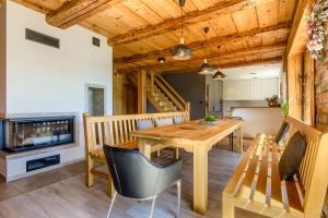 a dining room with a wooden table and a television at Dom Mazurski Tumiany 3 B in Tumiany
