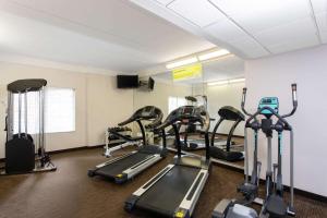 a gym with several treadmills and cardio machines at La Quinta by Wyndham Jacksonville Butler Blvd in Jacksonville