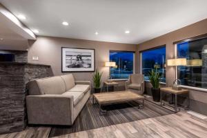 a living room with a couch and a table at La Quinta by Wyndham Anchorage Airport in Anchorage