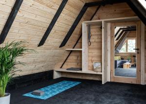 a room in a wooden house with a door at Mount Apart Sport House in Zakopane
