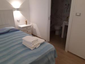 a bedroom with a bed and a dresser at Estatesalento in Leuca