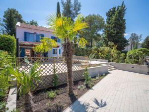 a palm tree in front of a house at Holiday Home Natali by Interhome in Njivice