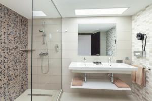 a bathroom with a sink and a shower at Hotel Riu Costa del Sol - All Inclusive in Torremolinos