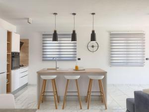 a kitchen with a kitchen island with stools at Villa Vine by Interhome in Marčana