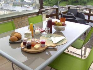 a table with a tray of food on a balcony at Le Valhento in Bouillon
