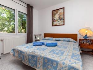 a bedroom with a bed with blue pillows on it at Holiday Home El Morer by Interhome in Llança