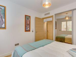 a bedroom with a bed and a mirror in it at Apartment Domaine Aïga-2 by Interhome in Soorts-Hossegor +12 photos