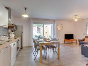 a kitchen and dining room with a table and a kitchen and a couch at Apartment Domaine Aïga-2 by Interhome in Soorts-Hossegor