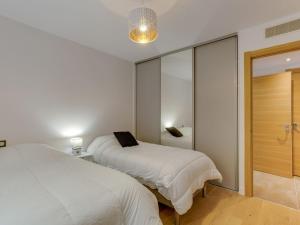 a bedroom with two beds and a sliding glass door at Apartment Domaine Aïga-2 by Interhome in Soorts-Hossegor