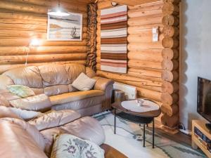 a living room with a couch and a table at Holiday Home Vuokatticottage c by Interhome in Vuokatti