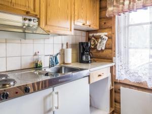 a kitchen with wooden cabinets and a sink at Holiday Home Vuokatticottage c by Interhome in Vuokatti