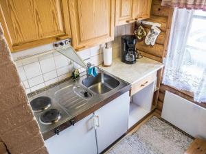a small kitchen with a sink in a tiny house at Holiday Home Vuokatticottage c by Interhome in Vuokatti