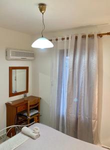 Posteľ alebo postele v izbe v ubytovaní Ifigenia Apartments