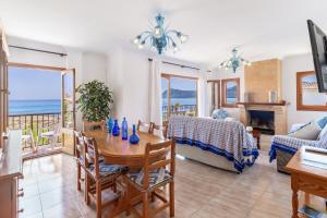 a living room with a table and a view of the ocean at Front Line Beach House Up To 6 Guests in Mallorca in Son Serra de Marina