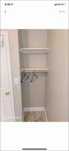 a white closet with shelves and a mirror at beautiful bedroom at central Baltimore in Baltimore