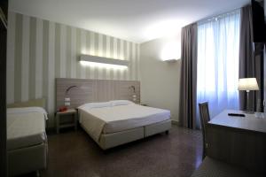 Posteľ alebo postele v izbe v ubytovaní Hotel Vittoria