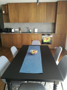 a black table with a bowl on it in a kitchen at Centro apartamentai in Birštonas