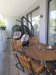 a wooden table and chairs sitting on a porch at Centro apartamentai in Birštonas