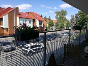 a balcony with a car parked in a parking lot at Centro apartamentai in Birštonas