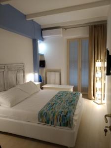 a bedroom with a large white bed and a window at Apulia 35 B&B in Bari