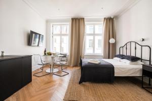 a bedroom with a bed and a table in it at Apartment Copernicus No. 25 in Toruń