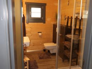 a small bathroom with a toilet and a window at Holiday Home Ferienhaus Barbara by Interhome in Enspel