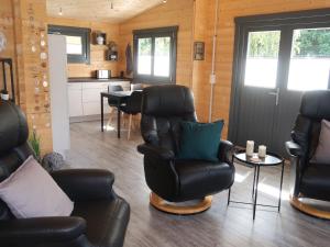 a room with chairs and a table and a kitchen at Holiday Home Ferienhaus Barbara by Interhome in Enspel