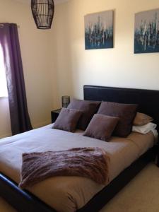 a bedroom with a large bed with brown pillows at Salt Air on Banyan in Warrnambool