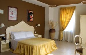 Postel nebo postele na pokoji v ubytování Hotel Capovilla