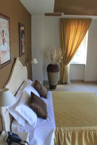 a bedroom with a bed with two pillows on it at Hotel Capovilla in Pisogne