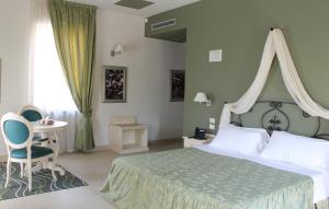 Postel nebo postele na pokoji v ubytování Hotel Capovilla