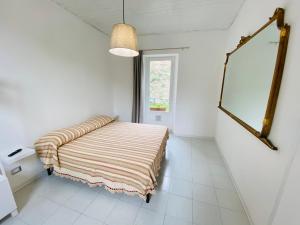 a bedroom with a bed in a white room at Il Cavalier Veggiani B&B in Mercato Saraceno