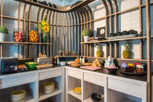 a room with shelves filled with food and desserts at ibis Styles Pertuis Portes du Luberon in Pertuis +92 photos