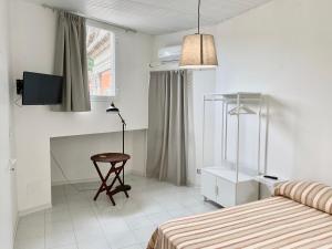 a bedroom with a bed and a table and a television at Il Cavalier Veggiani B&B in Mercato Saraceno