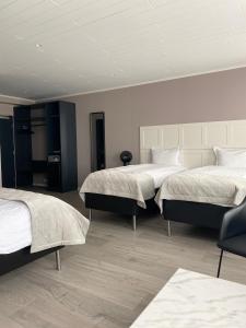 Ένα ή περισσότερα κρεβάτια σε δωμάτιο στο Midtown Hotel