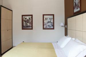 Postel nebo postele na pokoji v ubytování Hotel Capovilla