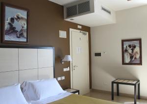 Postel nebo postele na pokoji v ubytování Hotel Capovilla