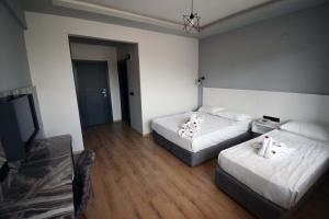 Postel nebo postele na pokoji v ubytování Aslan Sand & City Hotel