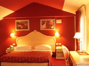 Postel nebo postele na pokoji v ubytování Hotel Capovilla