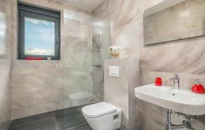 a bathroom with a toilet and a sink and a shower at VILA STEMARK in Njivice +43 photos
