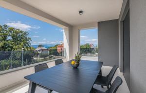 a dining room with a table and a large window at VILA STEMARK in Njivice