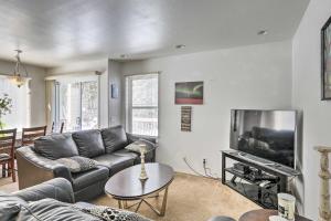 a living room with a couch and a tv at Peaceful Alaskan Escape 13 Mi to Fairbanks! in Fairbanks