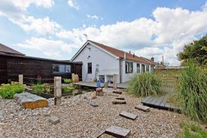 a house with a gravel yard in front of it at Big Sky in Camber