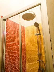 a shower with a glass door in a bathroom at Suite in vigneto in Passopisciaro