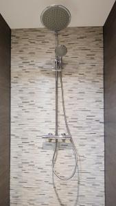 een douche met een douchekop in de badkamer bij Spacious 65m2 Apartment in the Centre of Eindhoven in Eindhoven